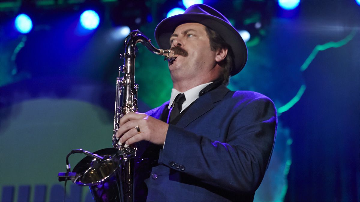 Duke Silver playing the saxophone under blue stage lights